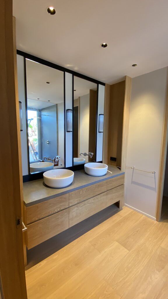 Baño reformado con lavabos sobre encimera de madera - Casa Freixa